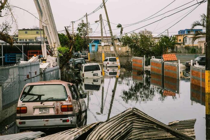 shutterstock_779256271 Flooded urban street with abandoned cars and downed power lines