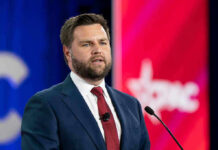 Munich Stunner: Vance Rewrites Ukraine Playbook Man in suit speaking at a podium with microphone