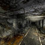 Abandoned underground mine tunnel with decaying supports