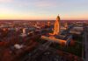 State capitol building at sunset overlooking a city