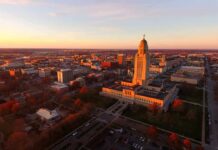 State capitol building at sunset overlooking a city