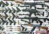 Twenty-Five States Want the Justices to Step In Wall display of assorted firearms in a gun shop