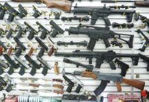 Twenty-Five States Want the Justices to Step In Wall display of assorted firearms in a gun shop