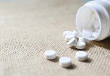 Parents Stunned: WHO OKs Teen Weight Drugs White tablets spilling from a plastic bottle