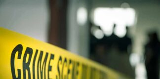 crime scene tape in a blurred indoor setting