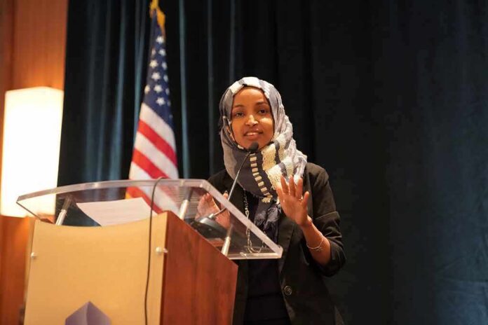 Woman in hijab speaking at a podium