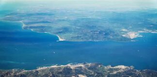 Aerial view of a coastal strait between mountainous landmasses