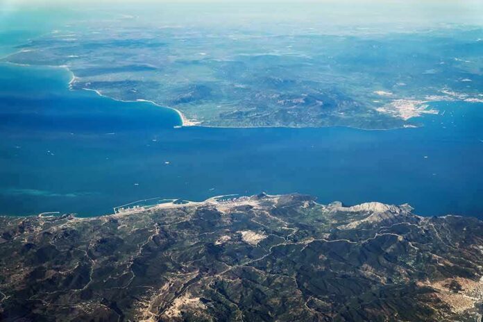 shutterstock_1324212995 Aerial view of a coastal strait between mountainous landmasses
