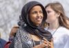 Empty Barrels Allegation Rocks Omar Ilhan Omar wearing a black headscarf at an outdoor event
