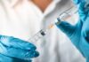 Deadly Measles Wave Jolts Pennsylvania Gloved hands drawing liquid into a syringe from a vial
