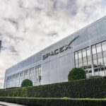 SpaceX headquarters exterior with rocket booster and hedge