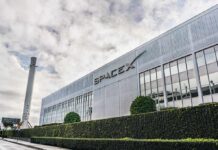 Musk Drops $10B Bomb – For Kids SpaceX headquarters exterior with rocket booster and hedge