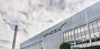 SpaceX headquarters exterior with rocket booster and hedge