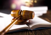 wooden gavel resting on open law book