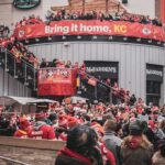 Christian Jones and Teddy Williams in a large outdoor crowd at a Kansas City football rally