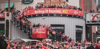 Christian Jones and Teddy Williams in a large outdoor crowd at a Kansas City football rally