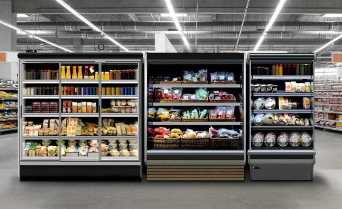 Supermarket refrigerated display cases with drinks, produce, and prepared foods