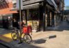 Driver Pay Doubled—but the Paychecks Didn’t Delivery bicycle parked outside a corner deli