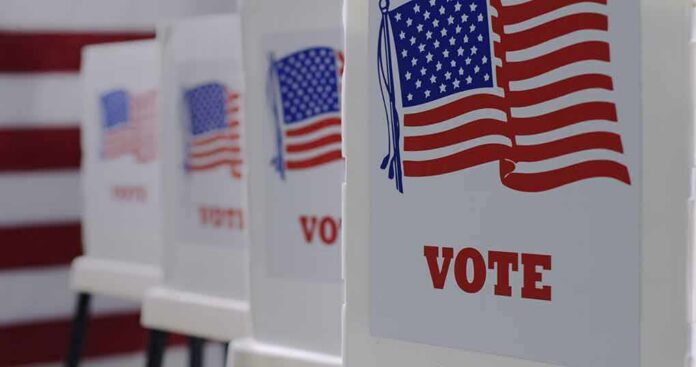 shutterstock_1743370412 Voting booths with American flag graphics