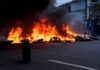 Street fire with burning tires and thick black smoke