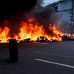 Street fire with burning tires and thick black smoke