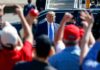 Diesel Spikes, Trump Support Surges Man in suit greeted by crowd with raised hands
