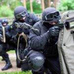 Tactical team advancing with ballistic shield and rifles