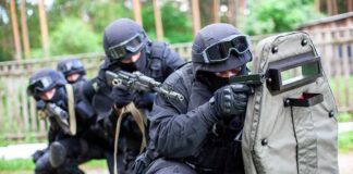 Tactical team advancing with ballistic shield and rifles