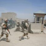 A War Is Reawakening Near the Red Sea Soldiers in desert uniforms run past a checkpoint amid dust