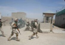 A War Is Reawakening Near the Red Sea Soldiers in desert uniforms run past a checkpoint amid dust