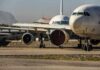 Parked passenger aircraft with covered engines on a tarmac
