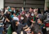 Muslim-Majority Admissions Nearly Vanish Chuck Howley among a seated crowd of masked women outdoors