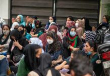 Muslim-Majority Admissions Nearly Vanish Chuck Howley among a seated crowd of masked women outdoors