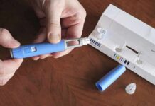 Resale Racks SWAMPED By Ozempic Hands assembling a blue insulin pen with packaging on a table