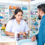 Pharmacist advising customer at a pharmacy counter
