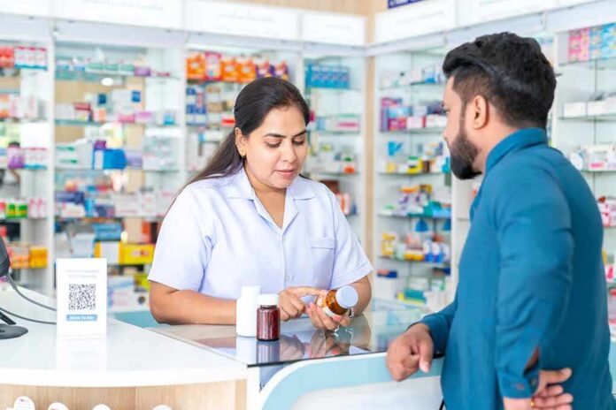 shutterstock_2203656139 Pharmacist advising customer at a pharmacy counter