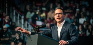 Josh Shapiro speaking at a podium before an audience