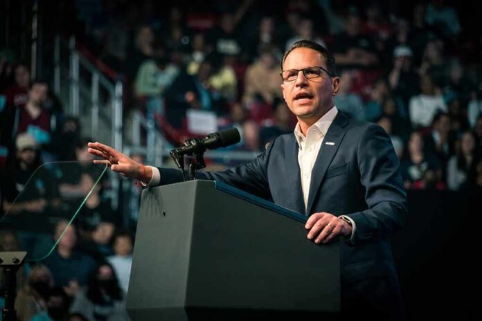 Josh Shapiro speaking at a podium before an audience