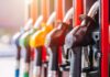 Red Fuel Goes Legal – Truckers Cheer Close-up of fuel pump nozzles at a gas station