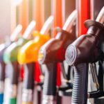Red Fuel Goes Legal – Truckers Cheer Close-up of fuel pump nozzles at a gas station