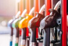 Red Fuel Goes Legal – Truckers Cheer Close-up of fuel pump nozzles at a gas station
