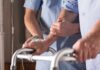 Trump Pledge Missing – Budgets Bleed Elderly person using a walker with caregiver support