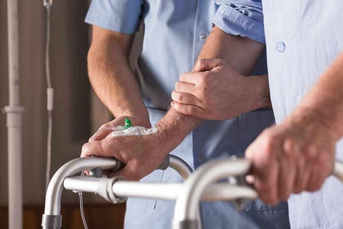 shutterstock_373694485 Elderly person using a walker with caregiver support
