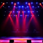 stage with red and blue spotlights shining onto an empty floor