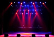 A Packed Arena Faces an Unexpected Scare stage with red and blue spotlights shining onto an empty floor