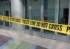 Yellow police tape blocking entrance to building