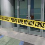 Yellow police tape blocking entrance to building
