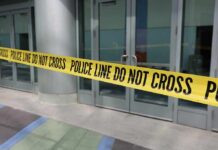 Yellow police tape blocking entrance to building