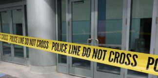 Yellow police tape blocking entrance to building