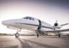 Court Ban Issued – Plane Touches Down Private jet on airport tarmac with open door at sunset